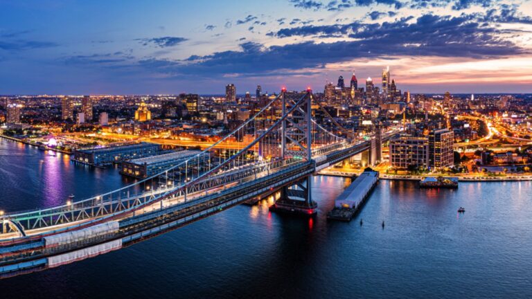 Ben Franklin Bridge and Philadelphia skyline at dusk viewed from above Cooper's Poynt Park, in Camden. Ben Franklin Bridge is a suspension bridge connecting Philadelphia and Camden, NJ.