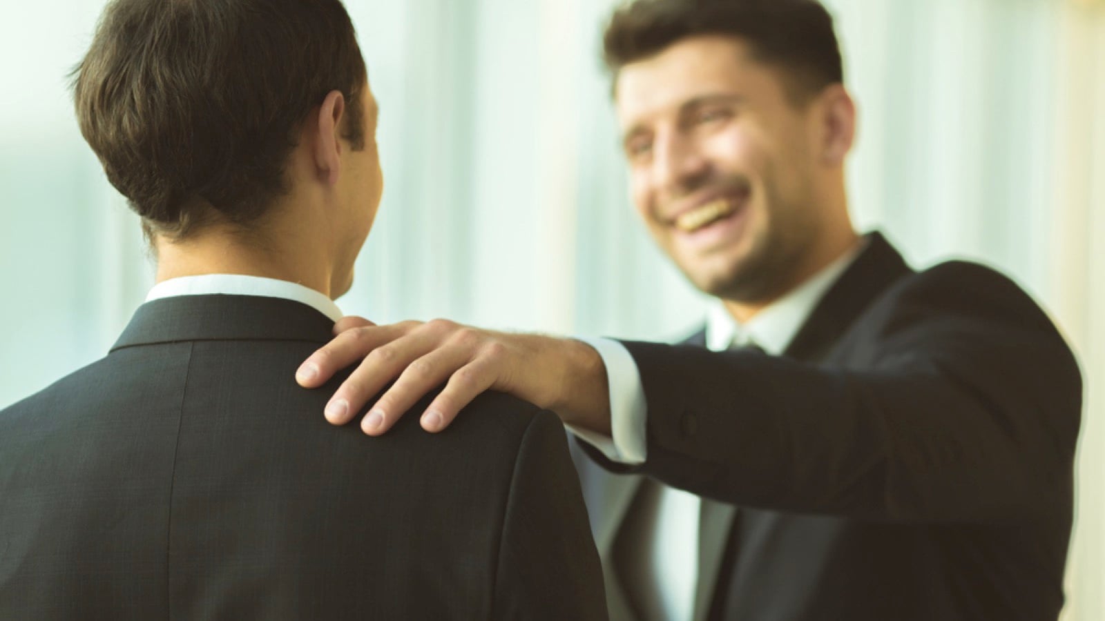 Boss congratulating employee