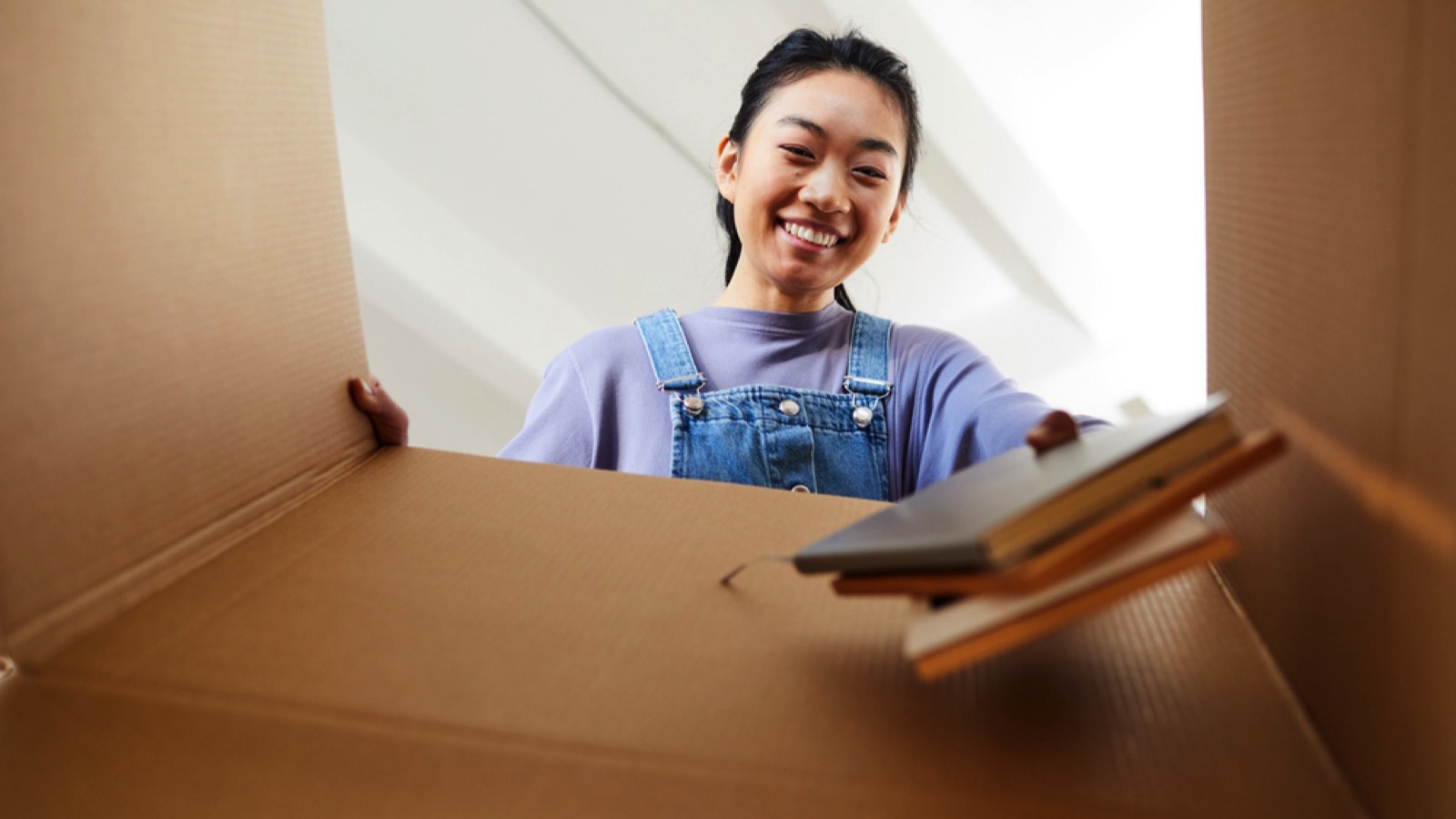 Happy woman decluttering books