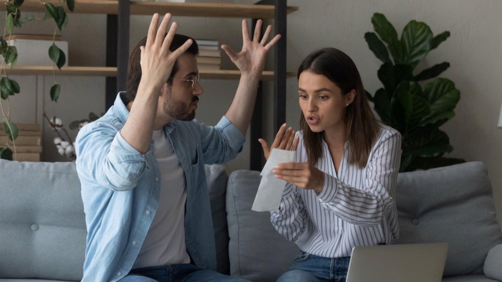 Woman fighting with boyfriend seeing bills