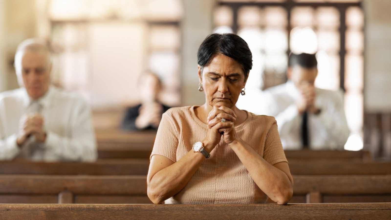 Woman praying in church