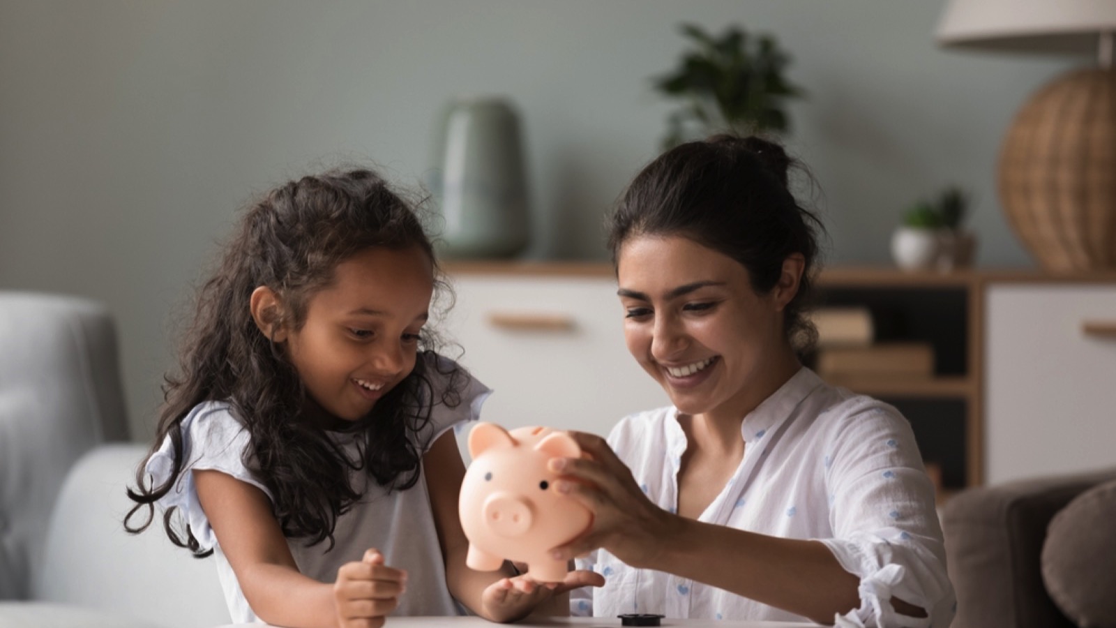 Woman with daughter saving money
