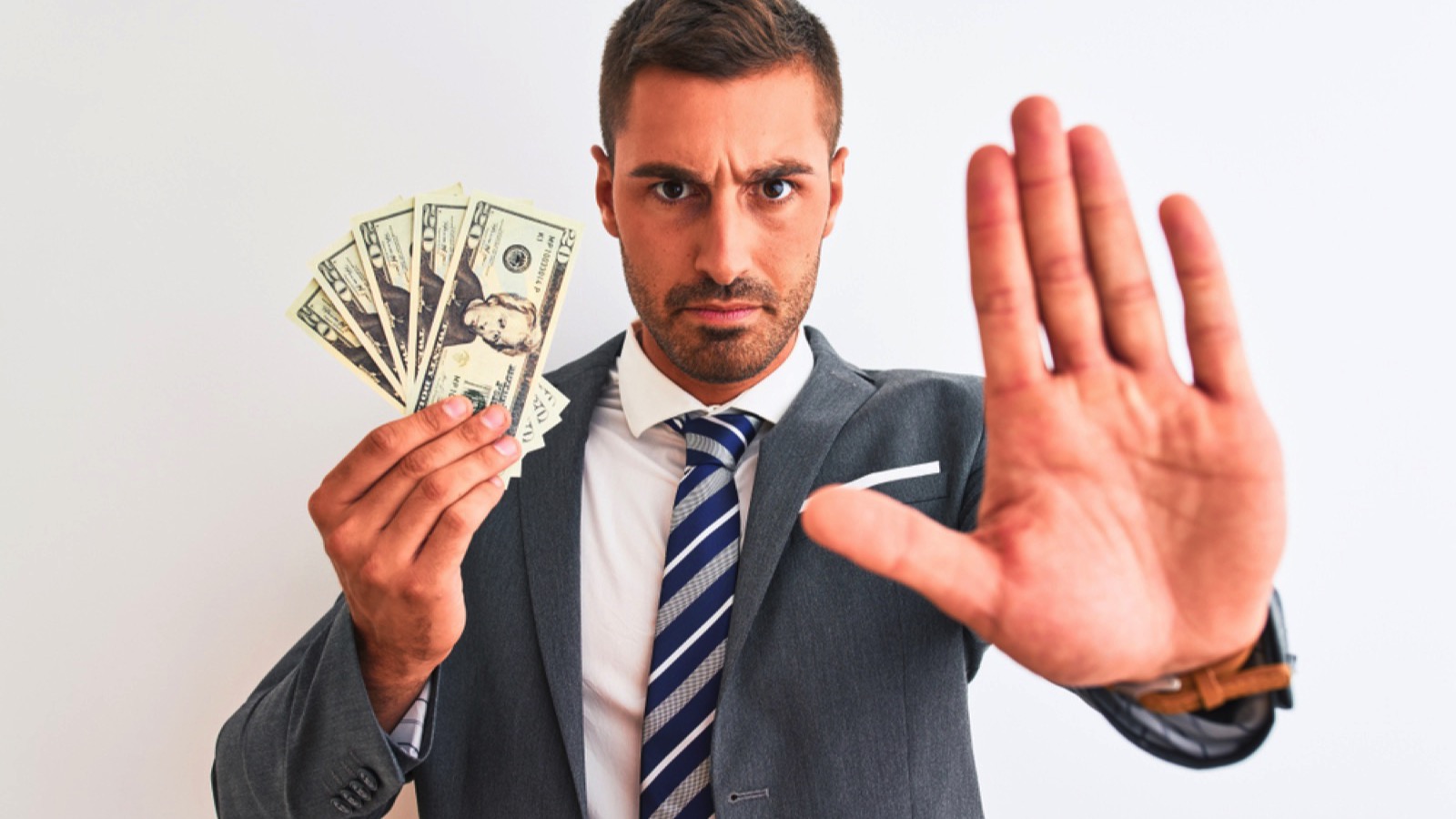 Young handsome business man holding bunch of money