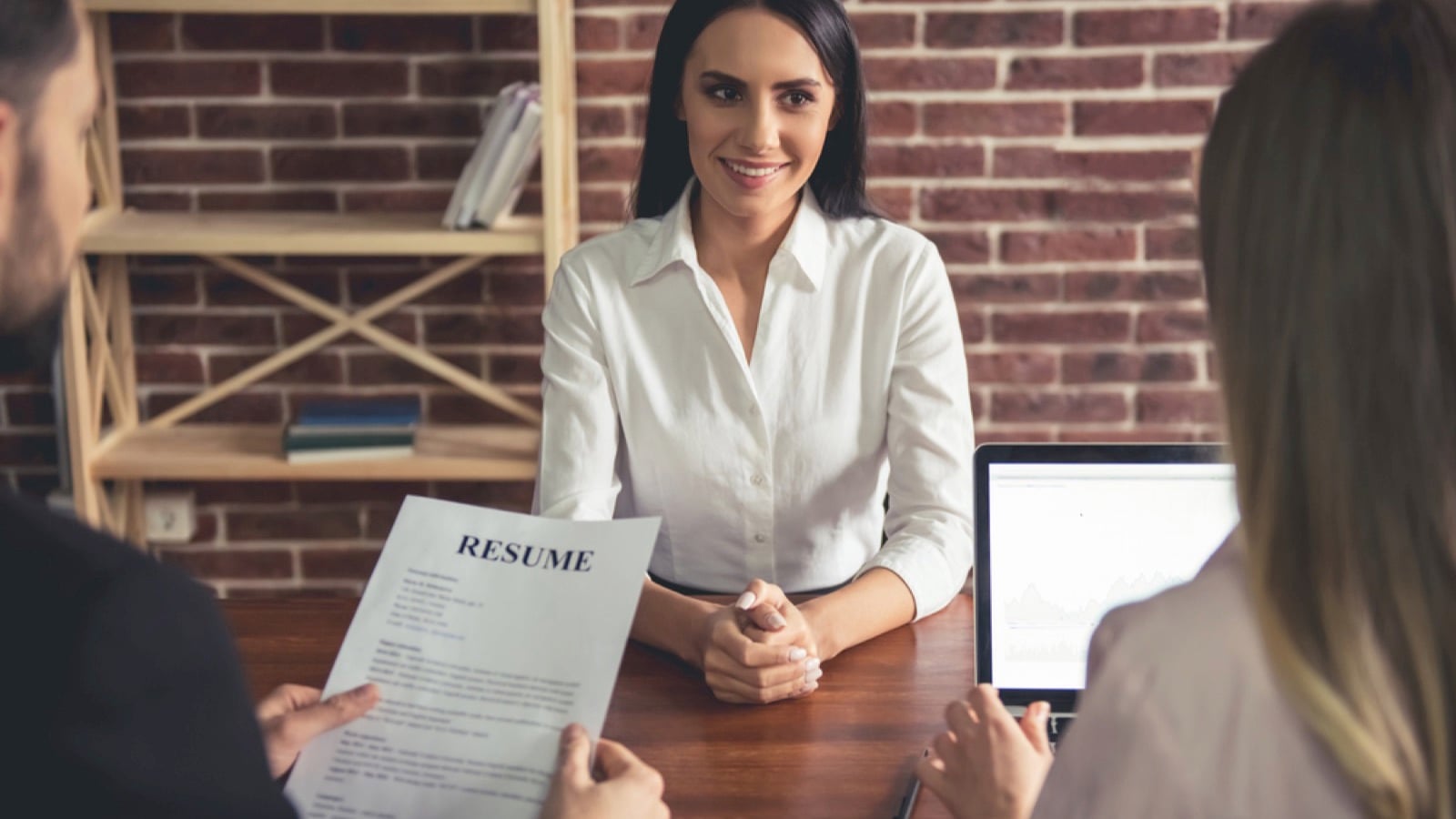 Beautiful female employee attending interview