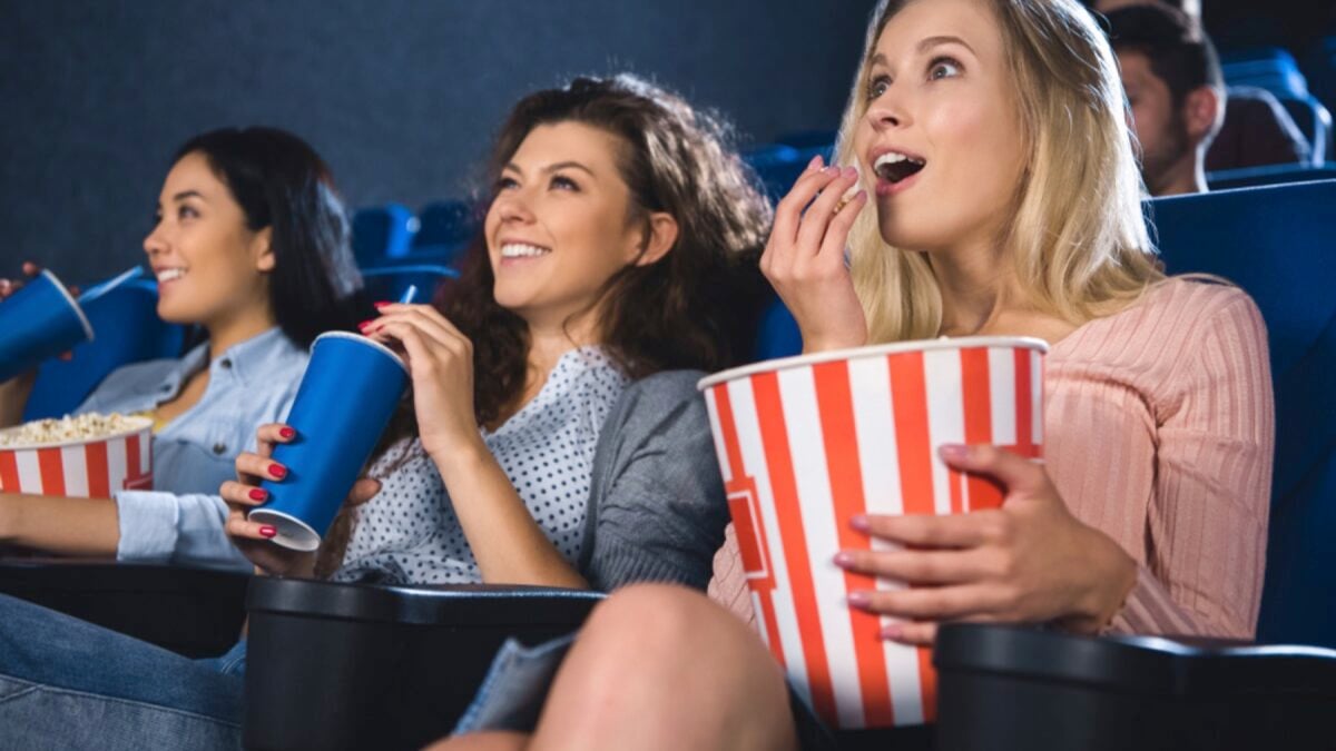 Friends enjoying movie in theatre