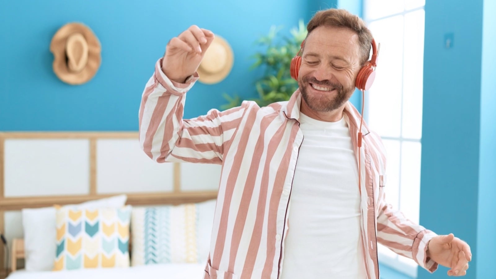 Happy man listening to music and dancing