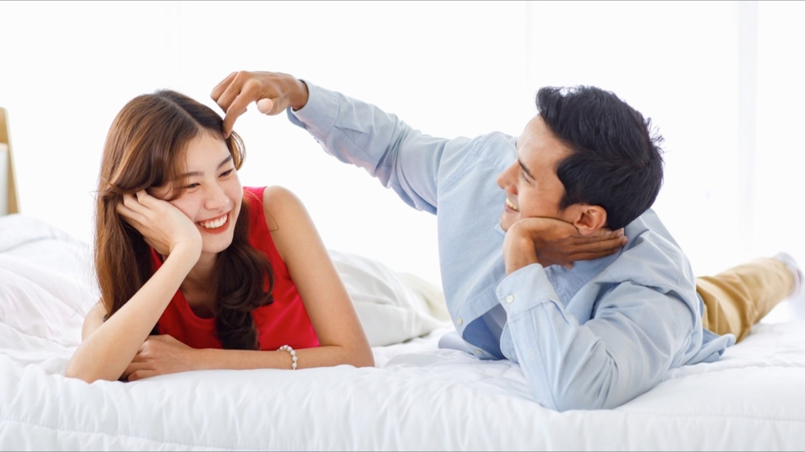 Man adjusting hair of his wife