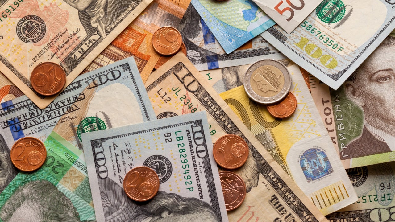 us dollars currency pile of notes and coins