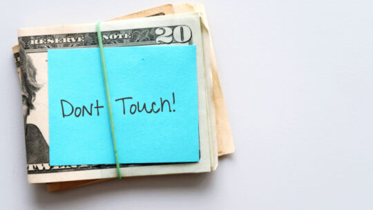 pile of money with a note that says don't touch