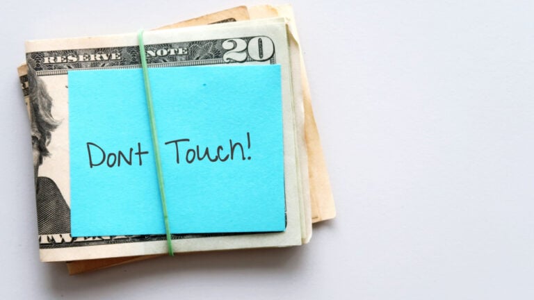 pile of money with a note that says don't touch