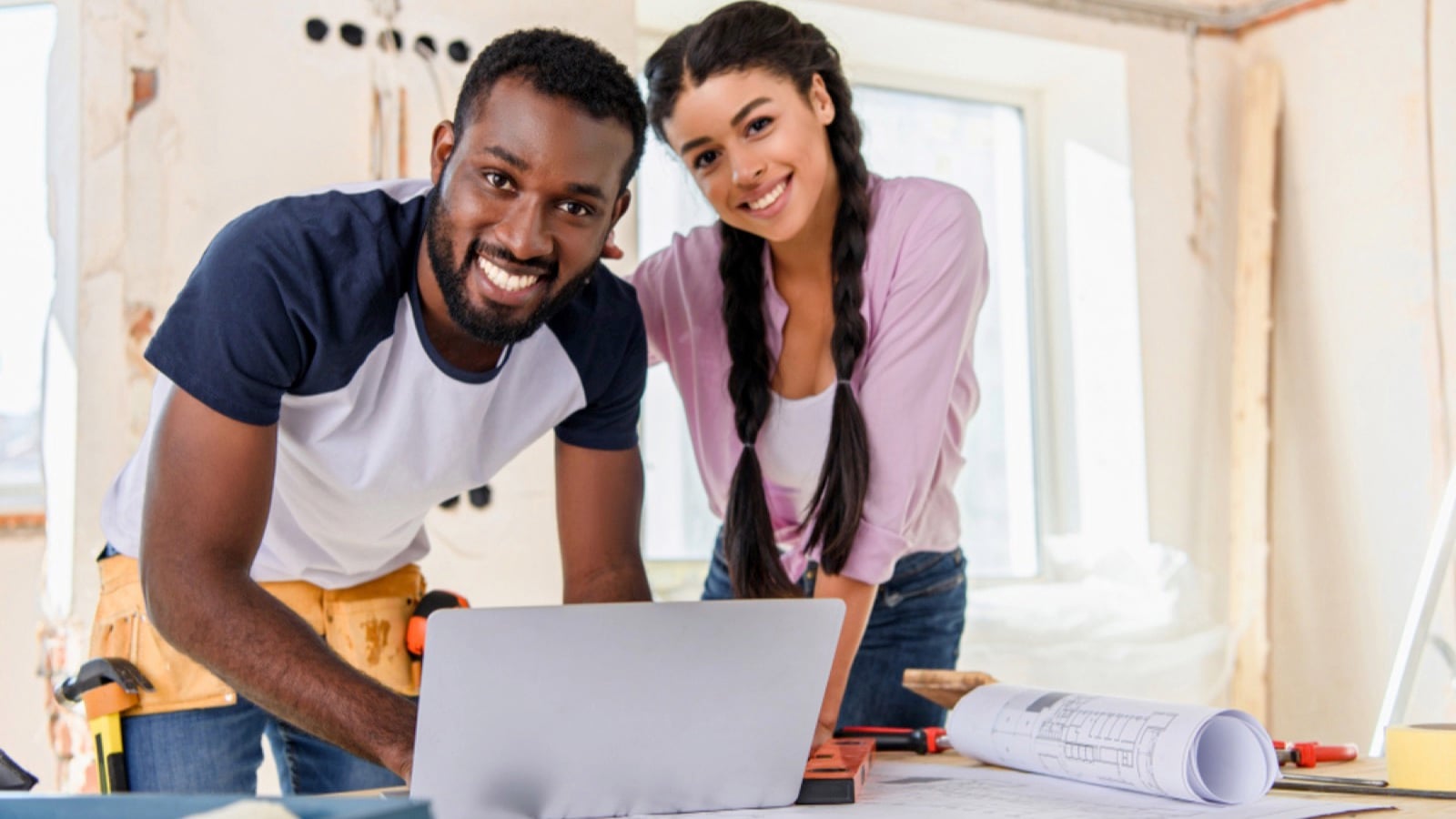 Smiling couple using laptop