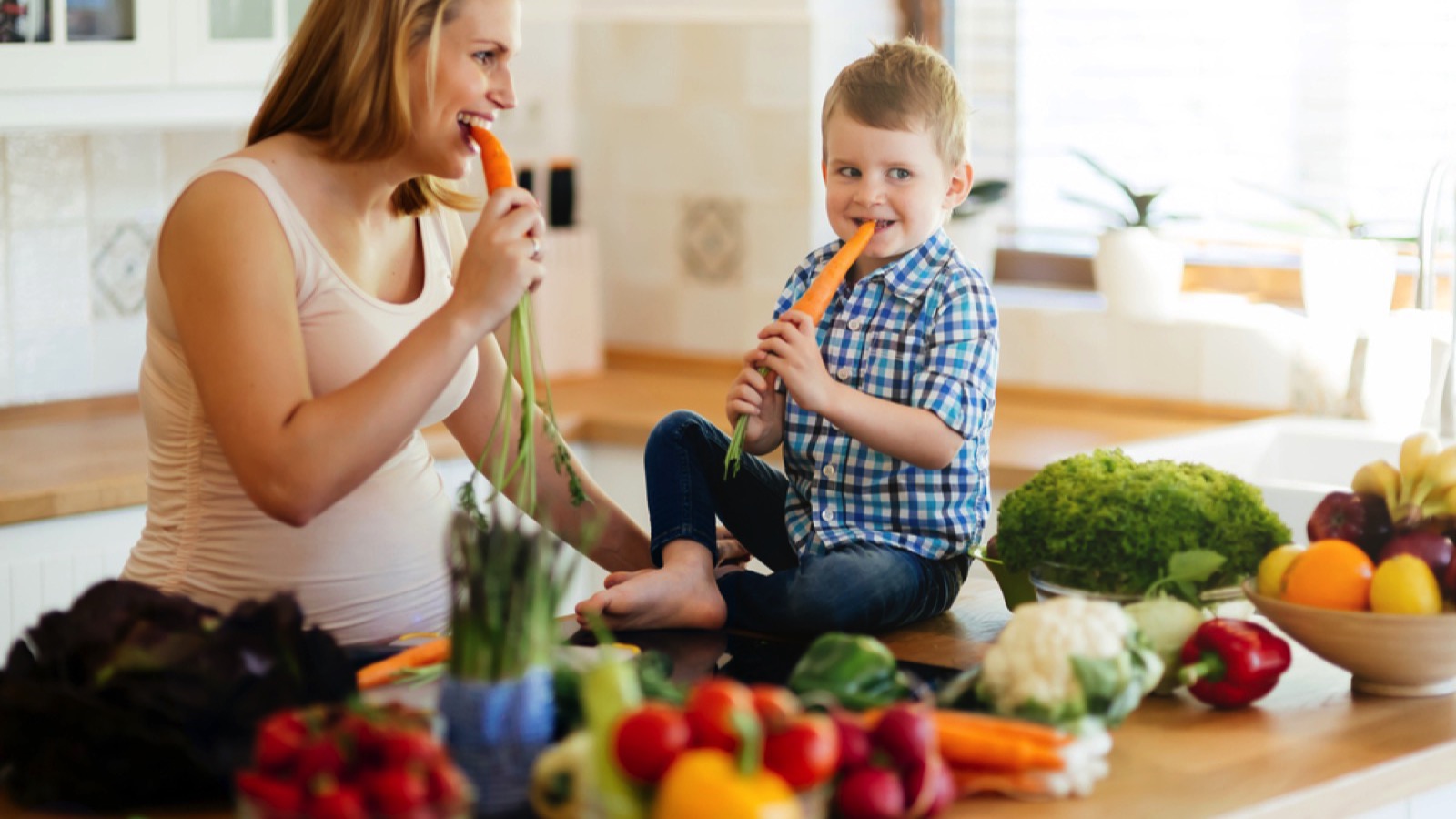 Toddler eating raw carrot