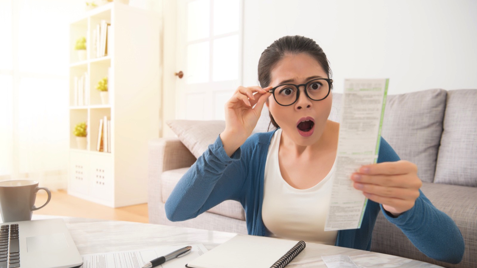 Woman checking bill and shocked