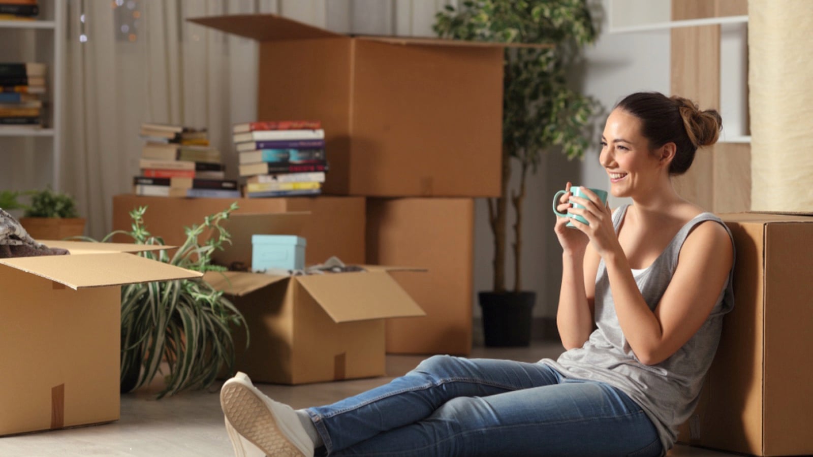 Woman having coffee in new house