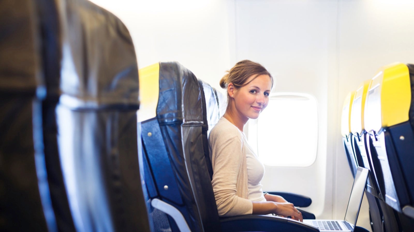 Woman on flight with laptop