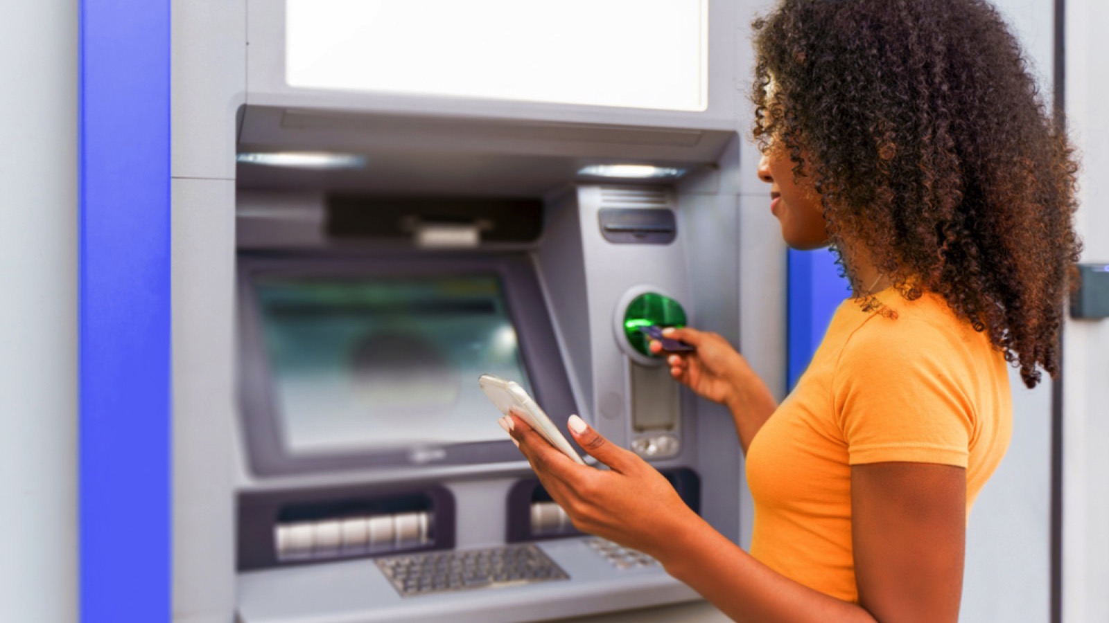 Woman using ATM