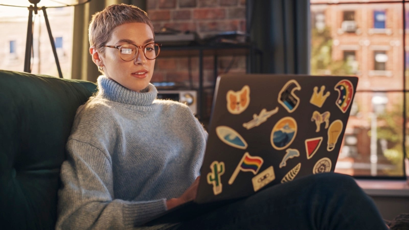 Woman using laptop with stickers