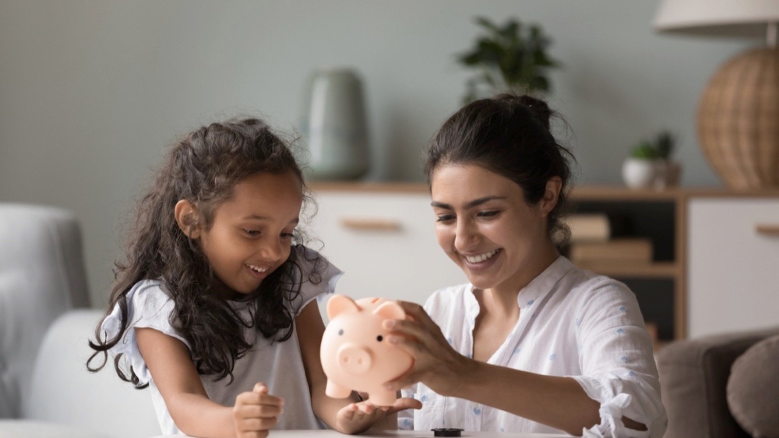 Woman with daughter saving money