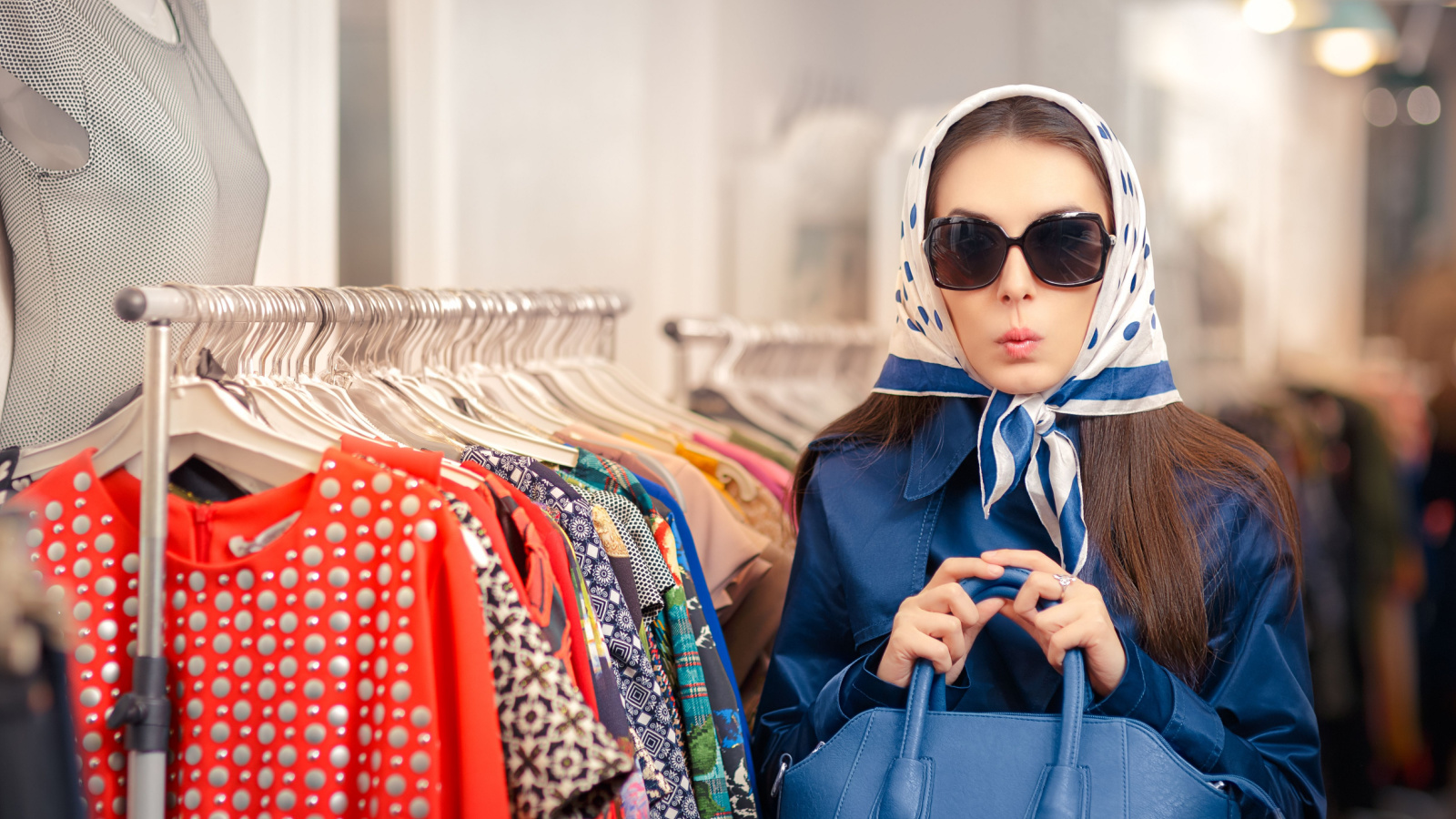 mystery shopper sitting by clothes in dark glasses