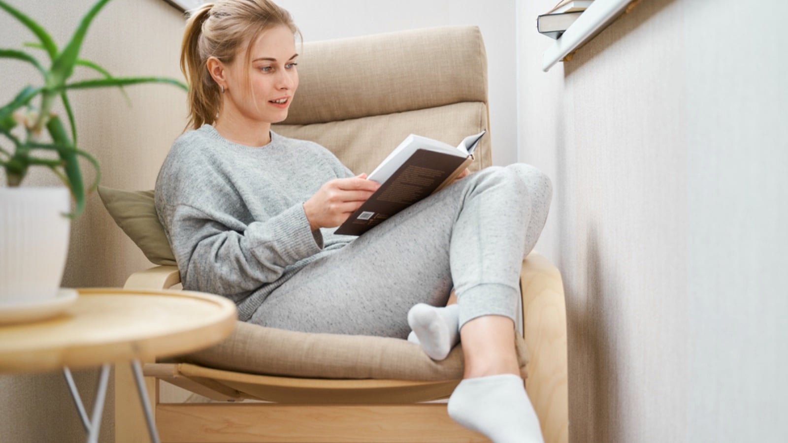 Blonde woman reading book