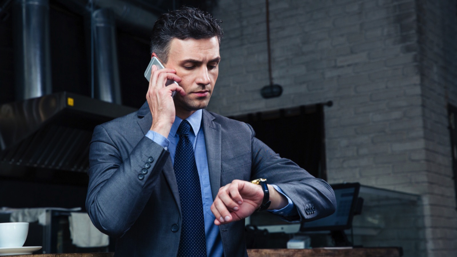 Businessman looking at watch for meeting
