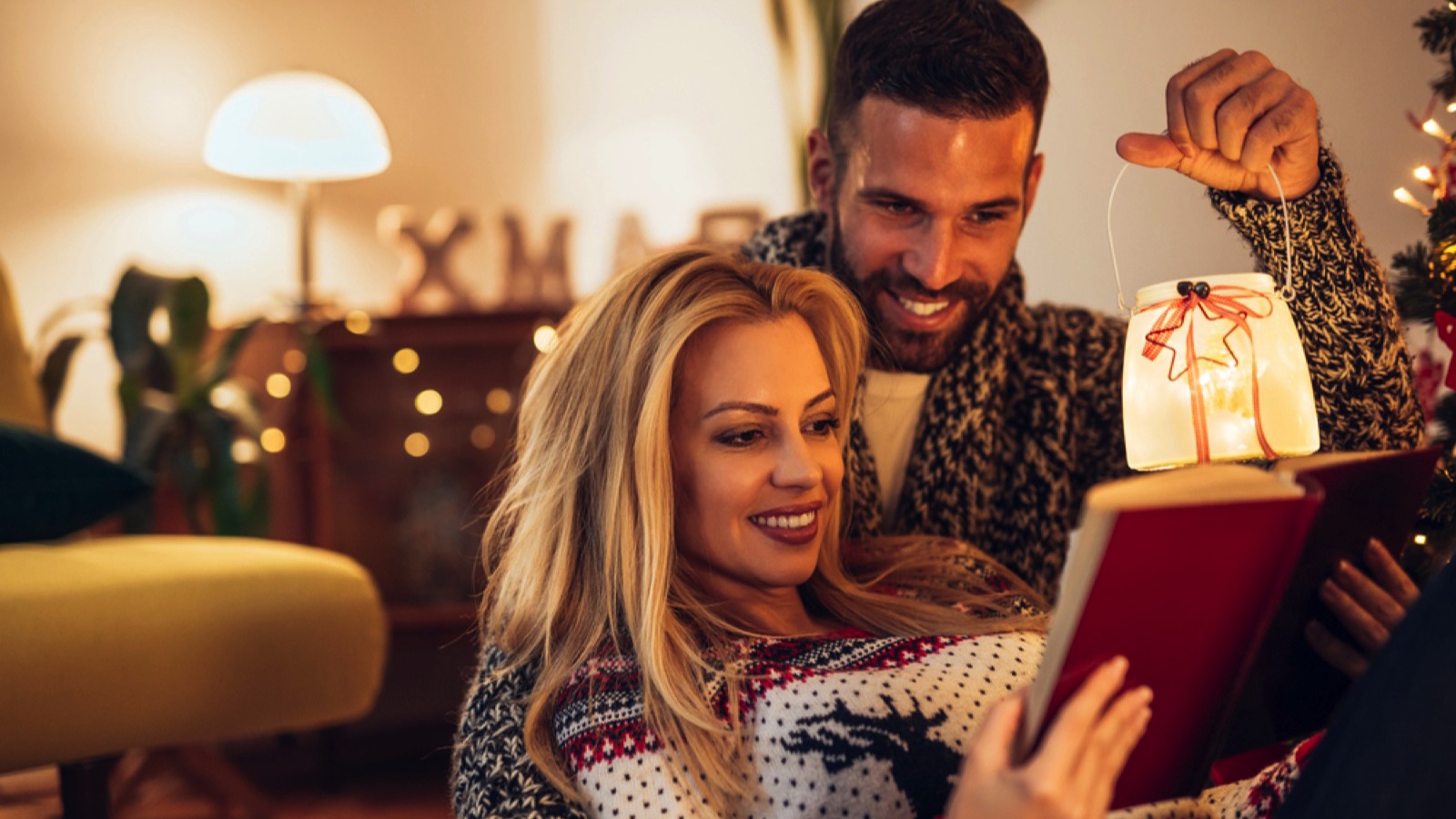 Couples enjoy reading book at home