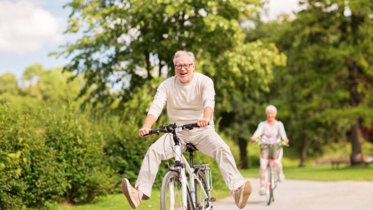 Happy couples riding bicycle enjoying