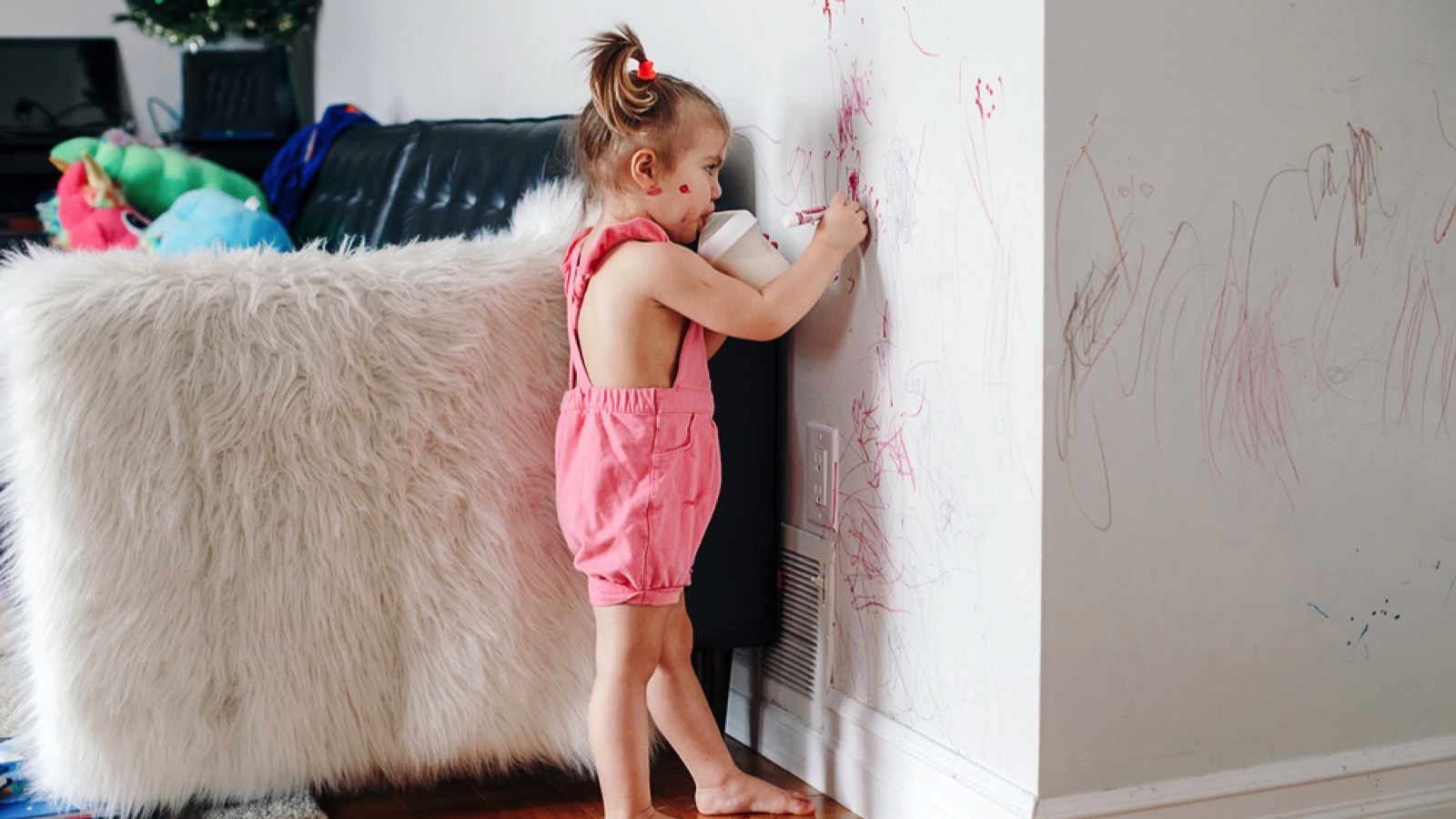 Kid scribbling on wall