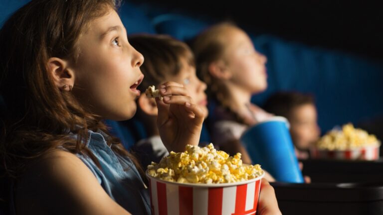 Kid watching movie in theatre