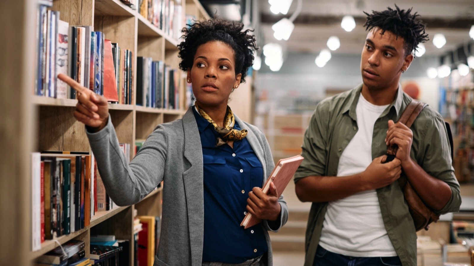 Librarian helping student