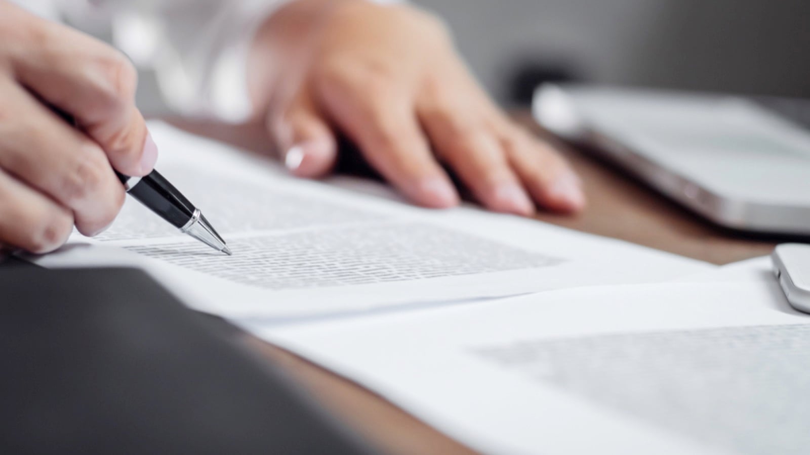 Man reading and signing document
