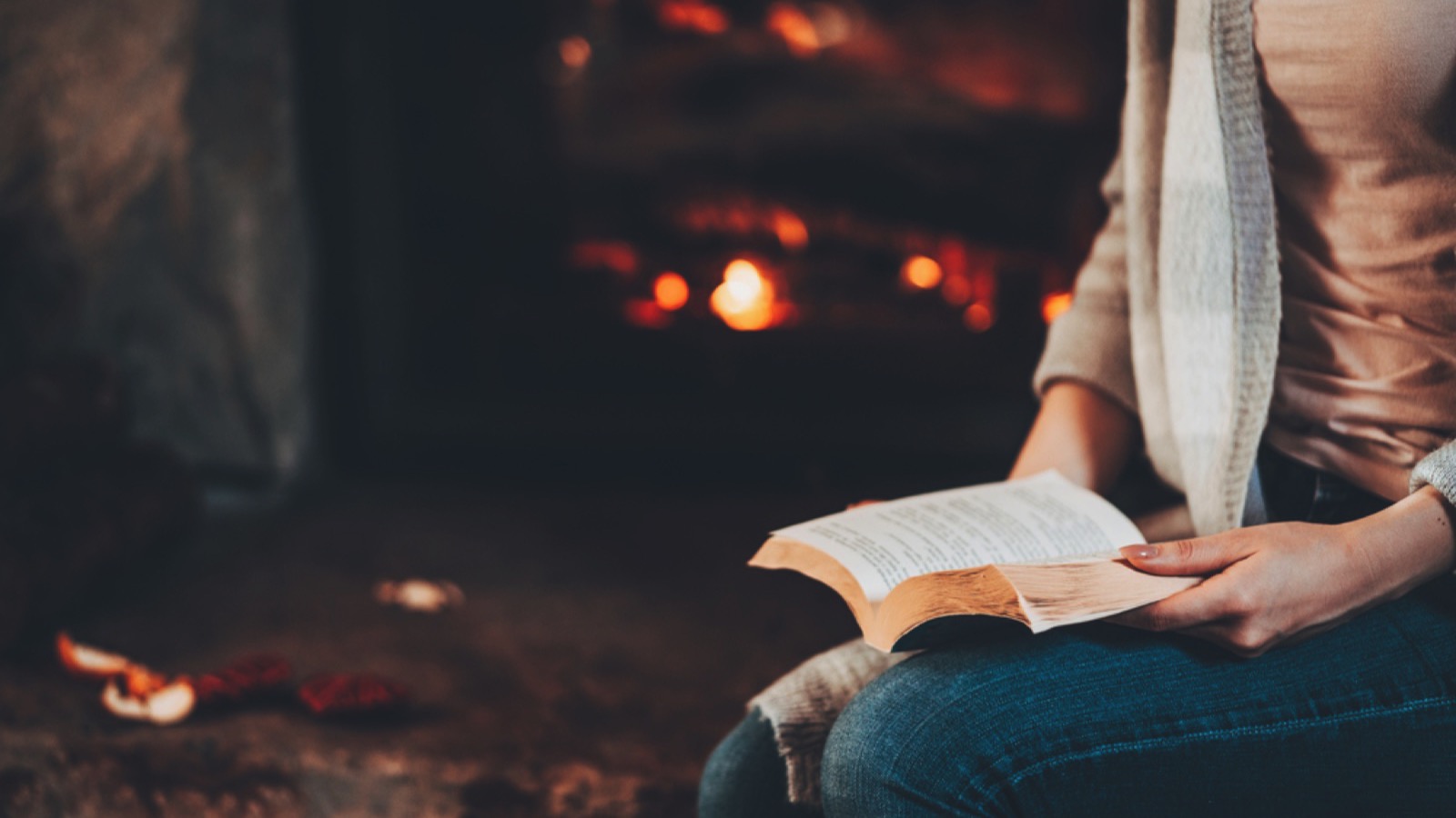 Reading book near fire