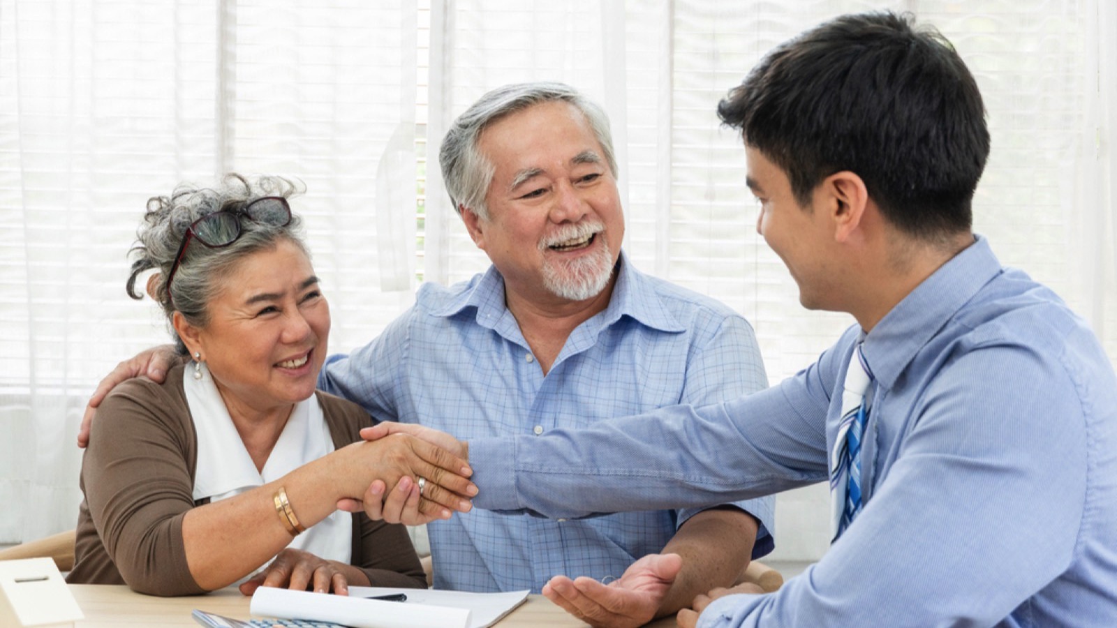 Salesman handshake with asian old couples