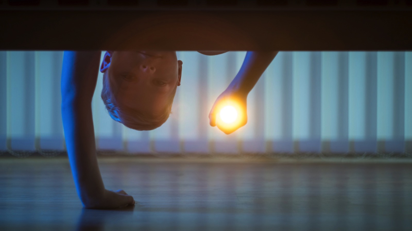 Scared Kid looking under bed