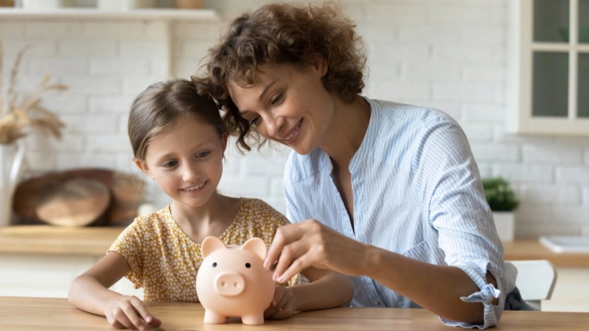 Woman and child saving in piggy bank