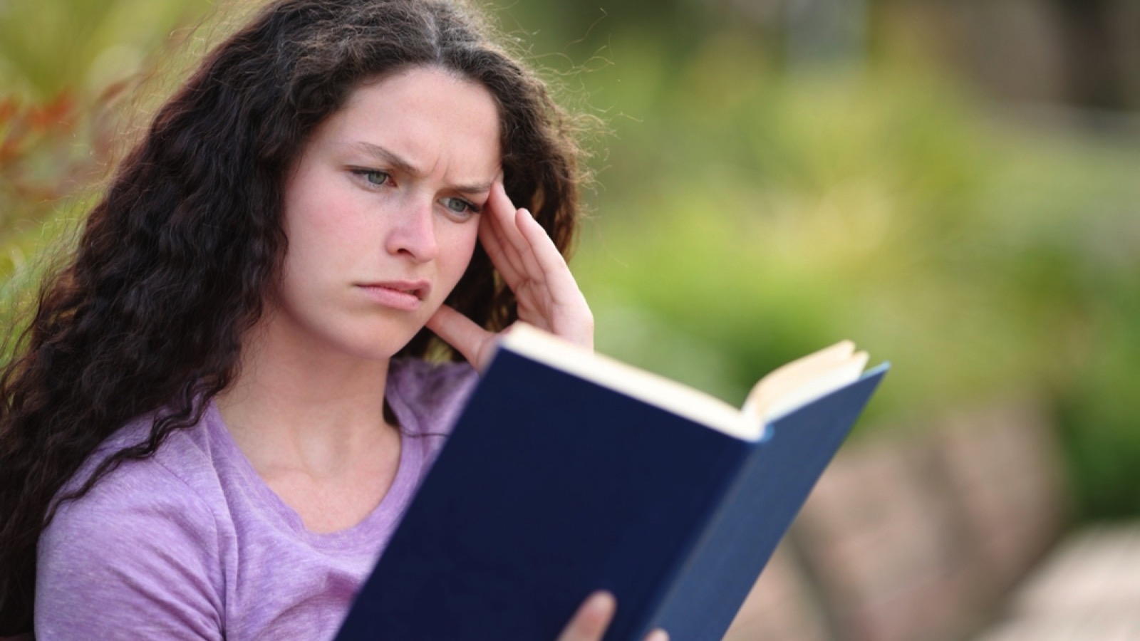 Woman confused irritated reading book