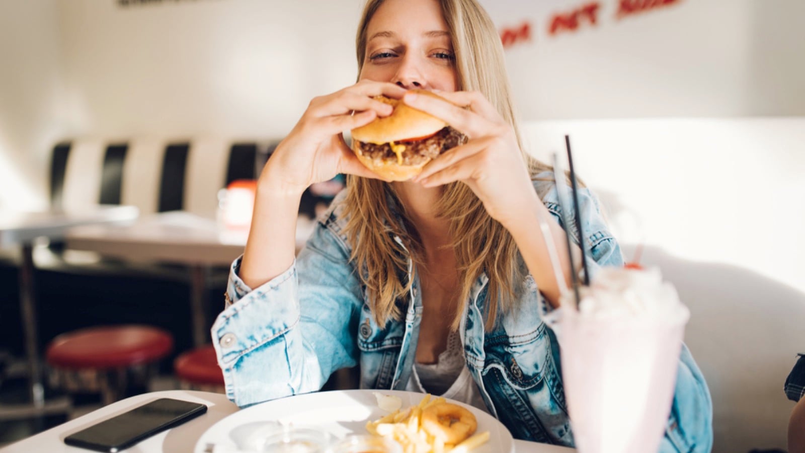 Woman eating cheese burger