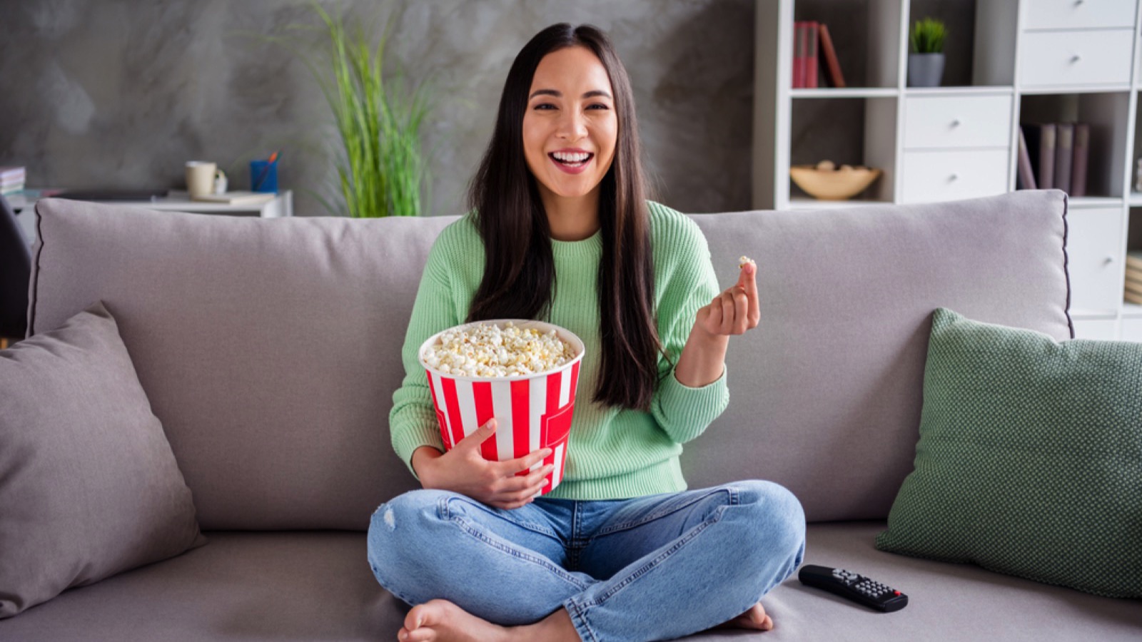 Woman laughing watching tv