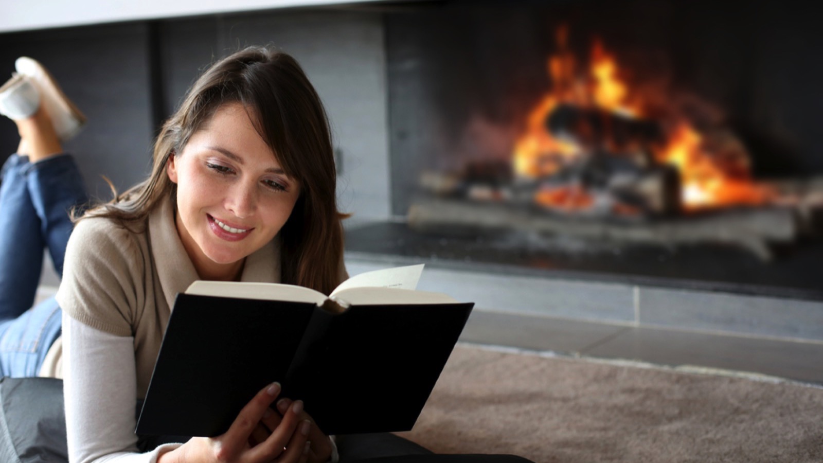 Woman lying down and reading book