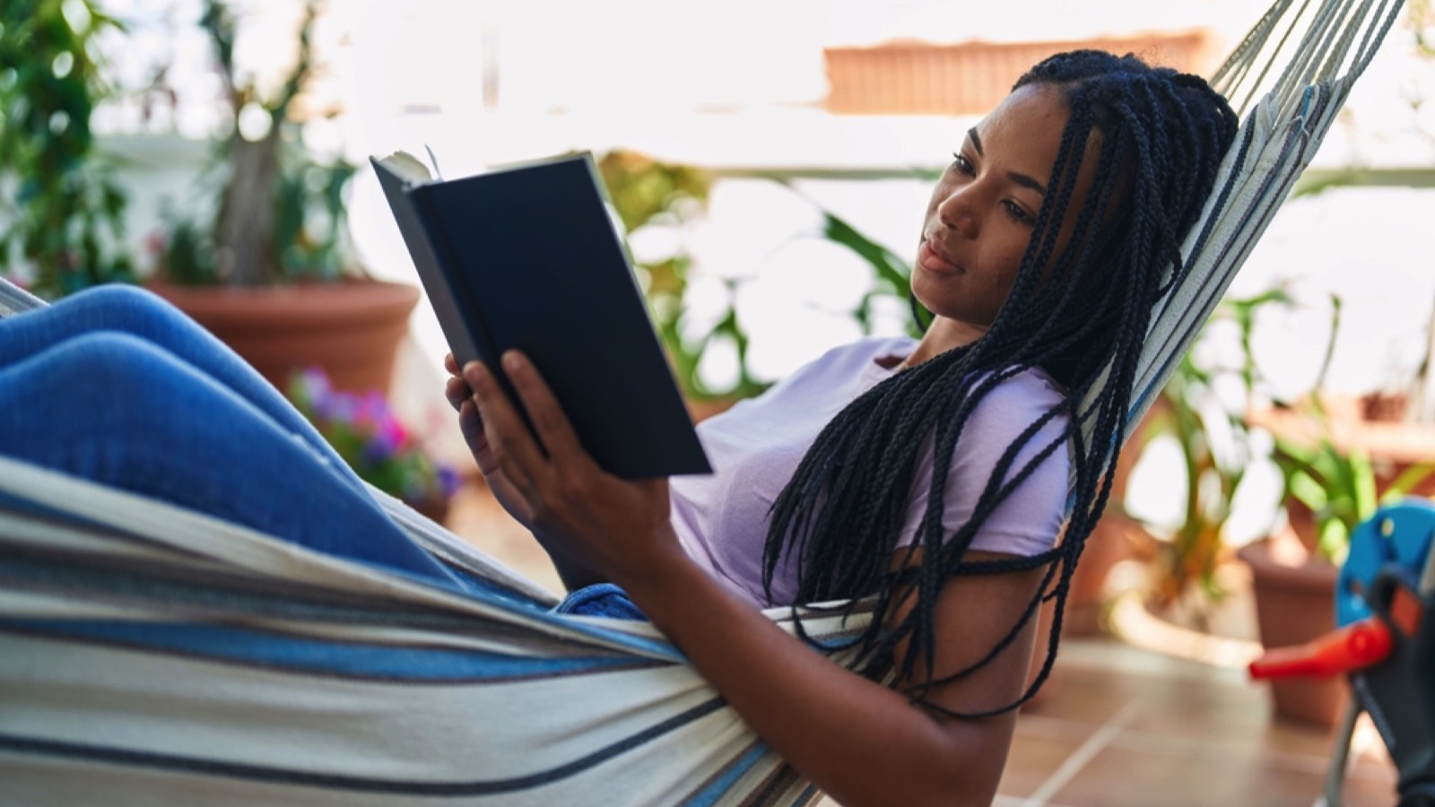 Woman on swing reading book
