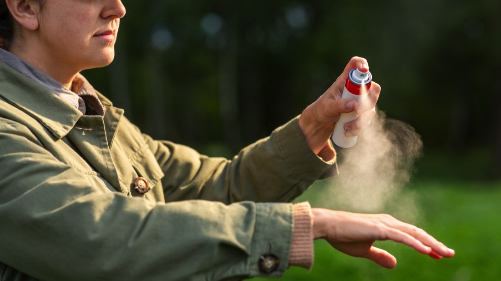 Woman using bug spray