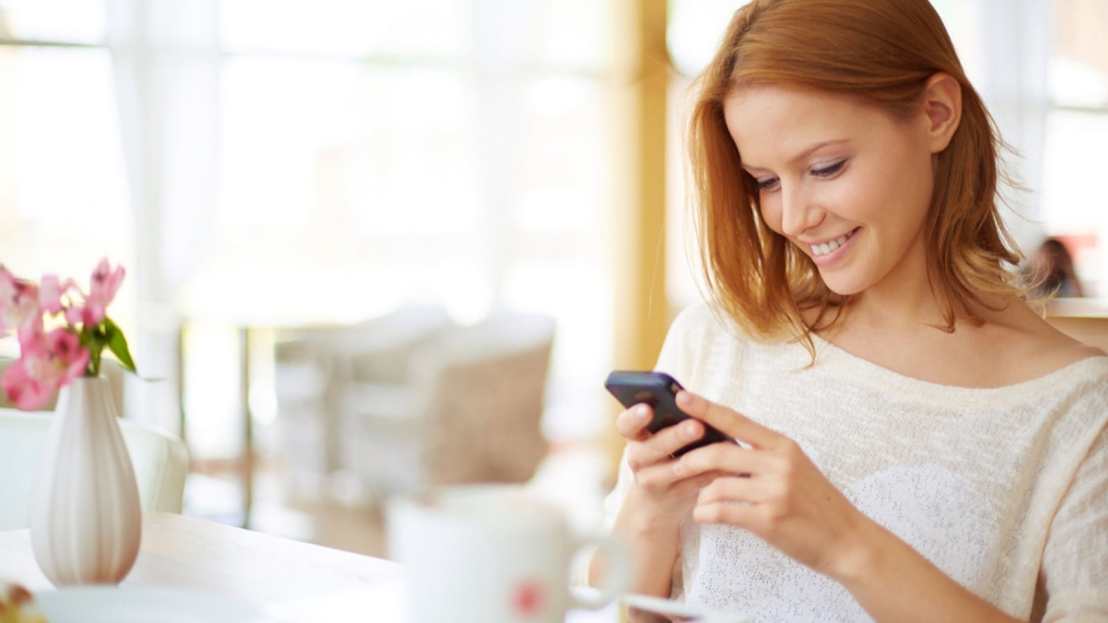 Woman using mobile chating with friend