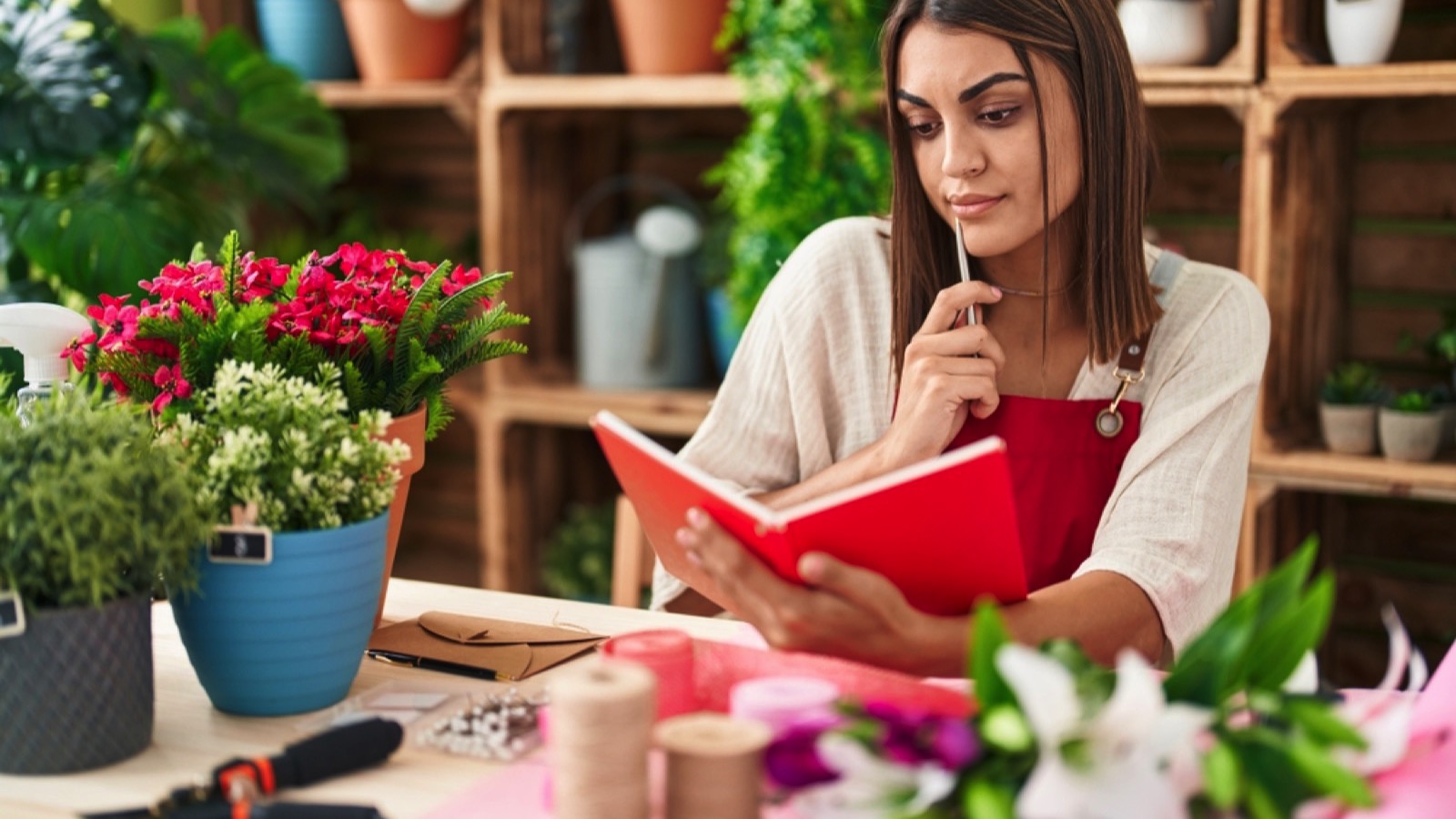 Young hispanic woman reading book