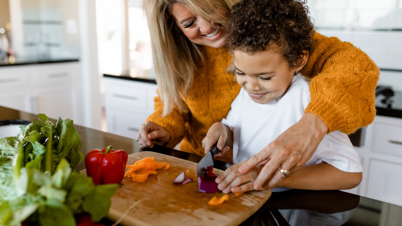 Family preparing vegetables at home to cook