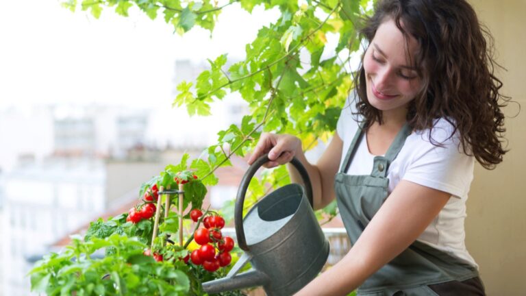 Young woman watering plants