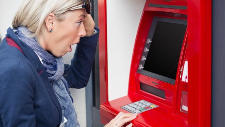 Shocked,Woman,Looking,At,Her,Bank,Account,Balance