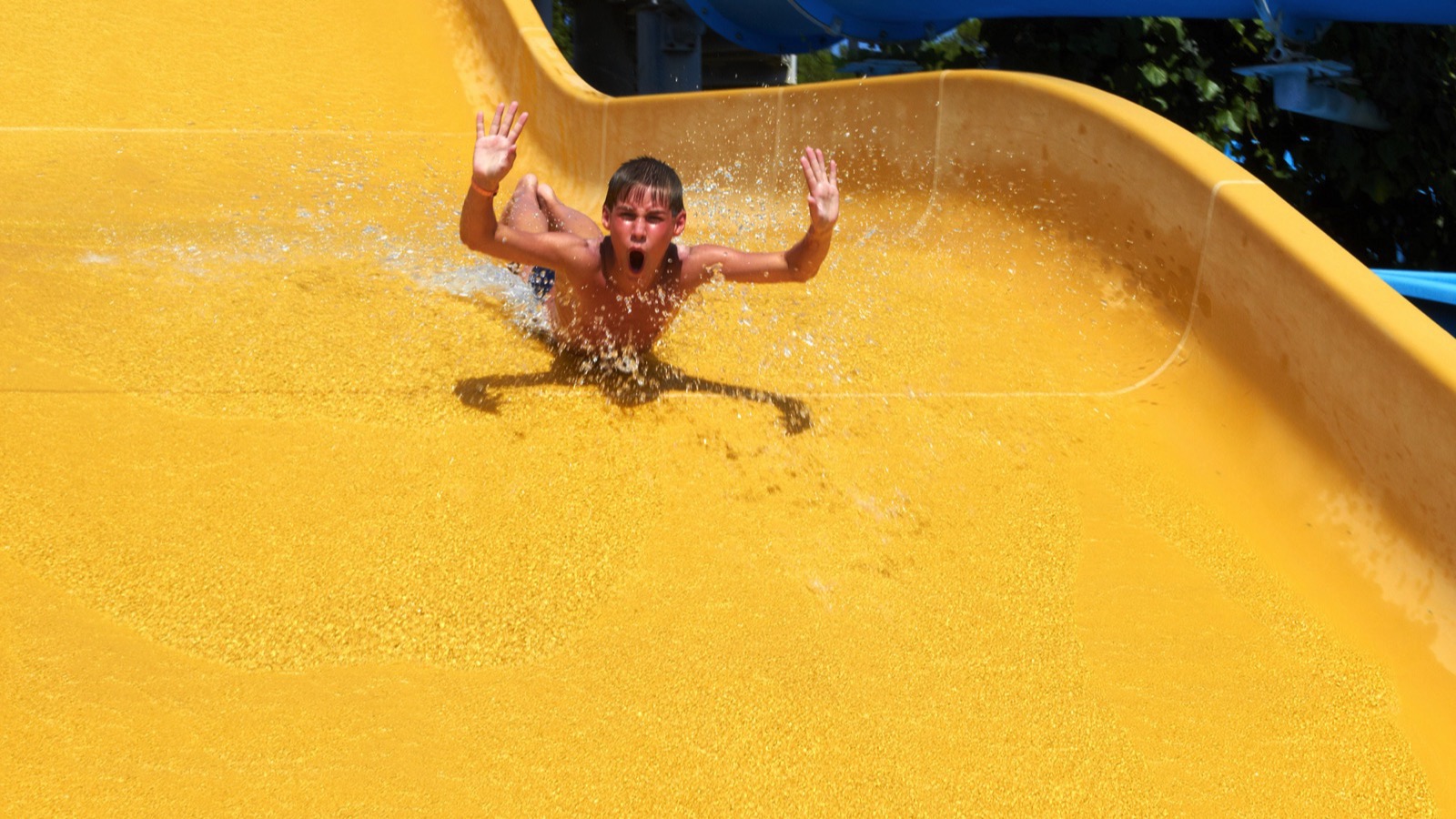 Boy rolling with slide at water park