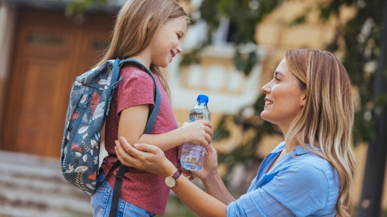 Busy mom greeting her child after school