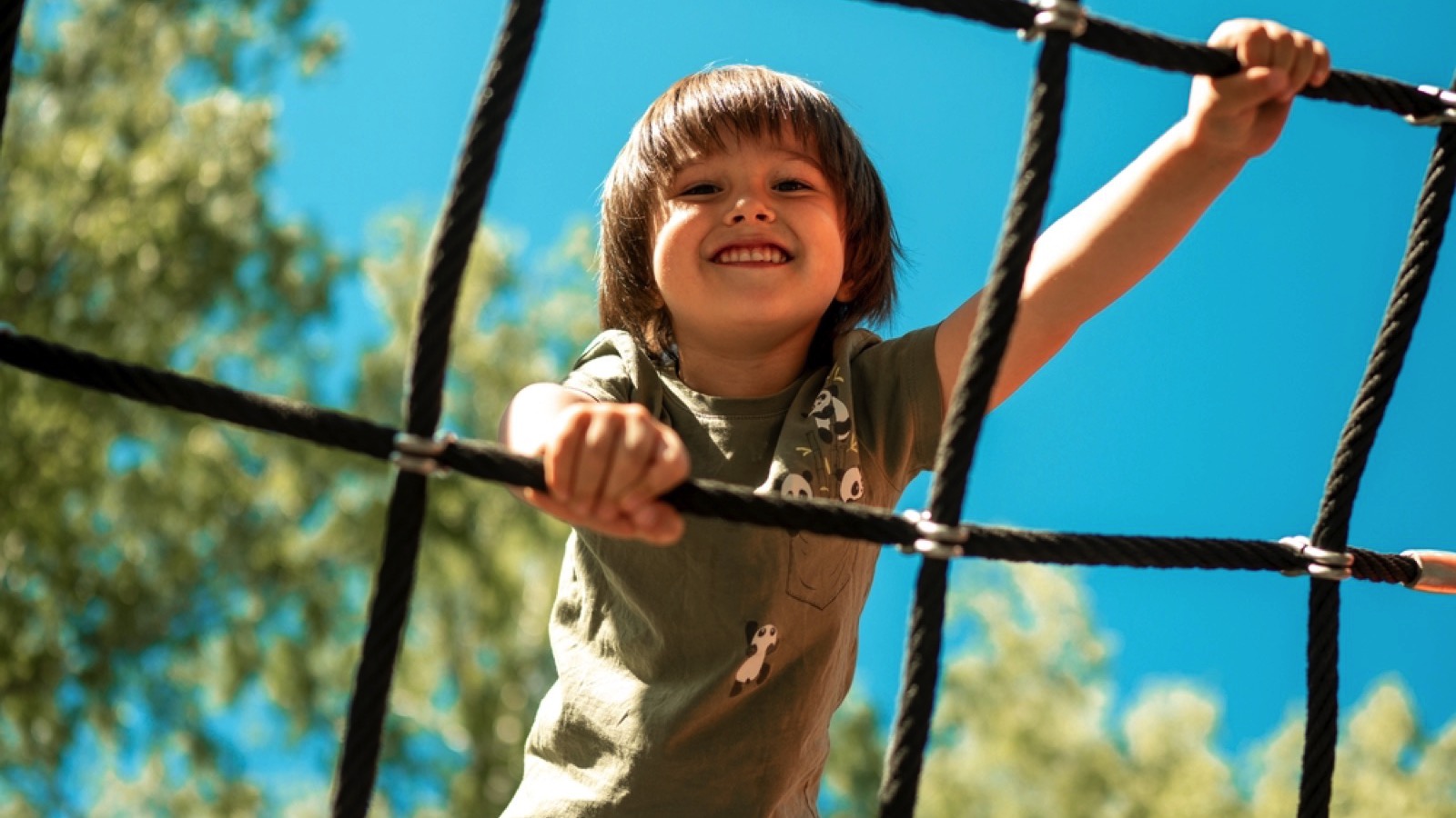 Child climbing up the grid