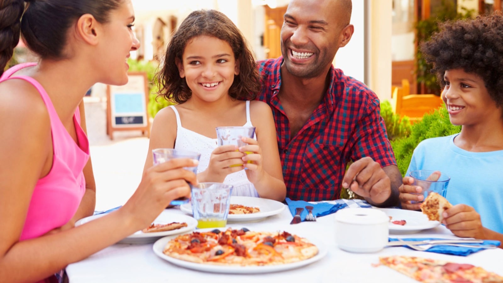 Family eating Pizza in restaurant